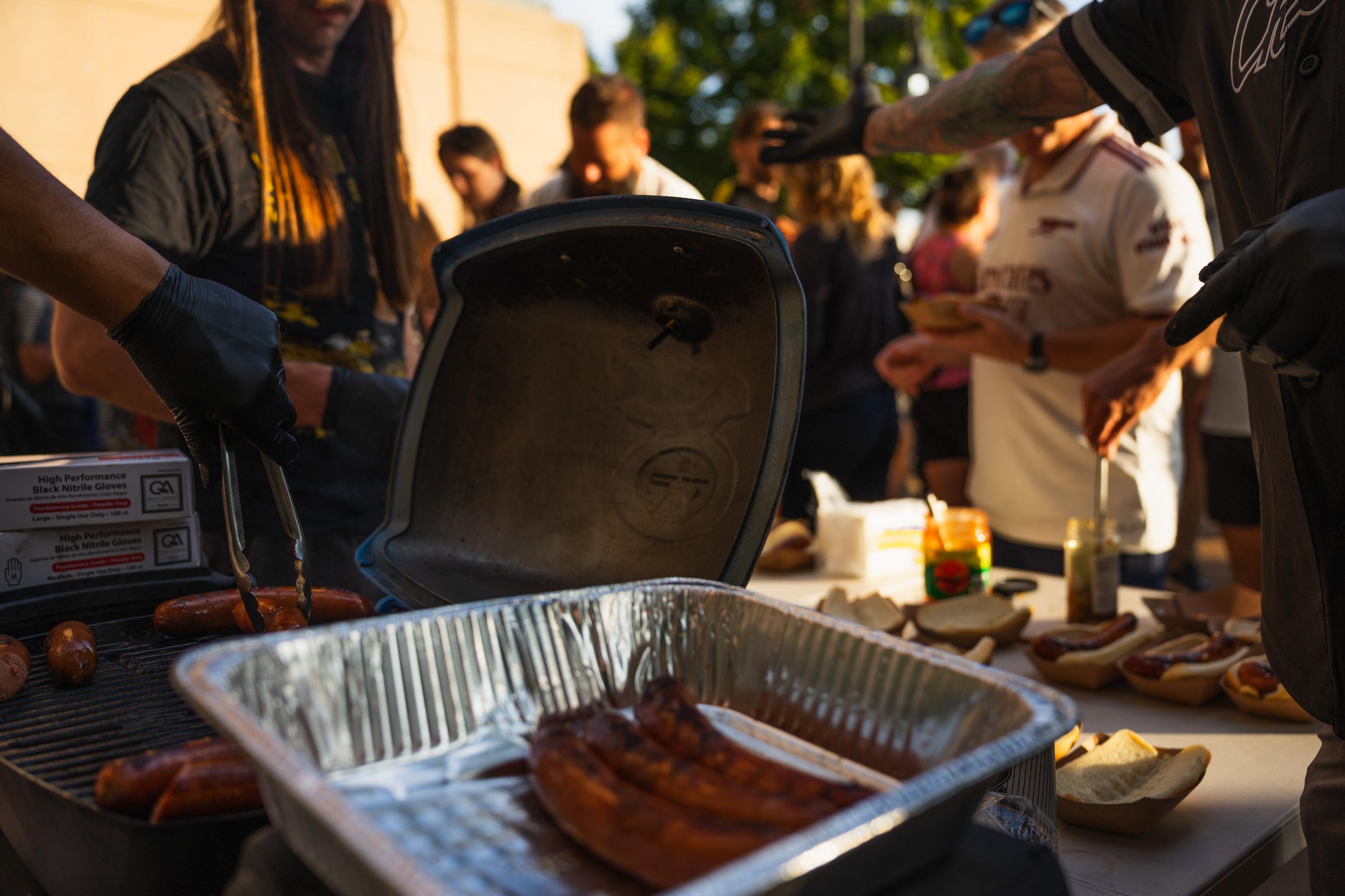 Bratwursts are served to bikers.